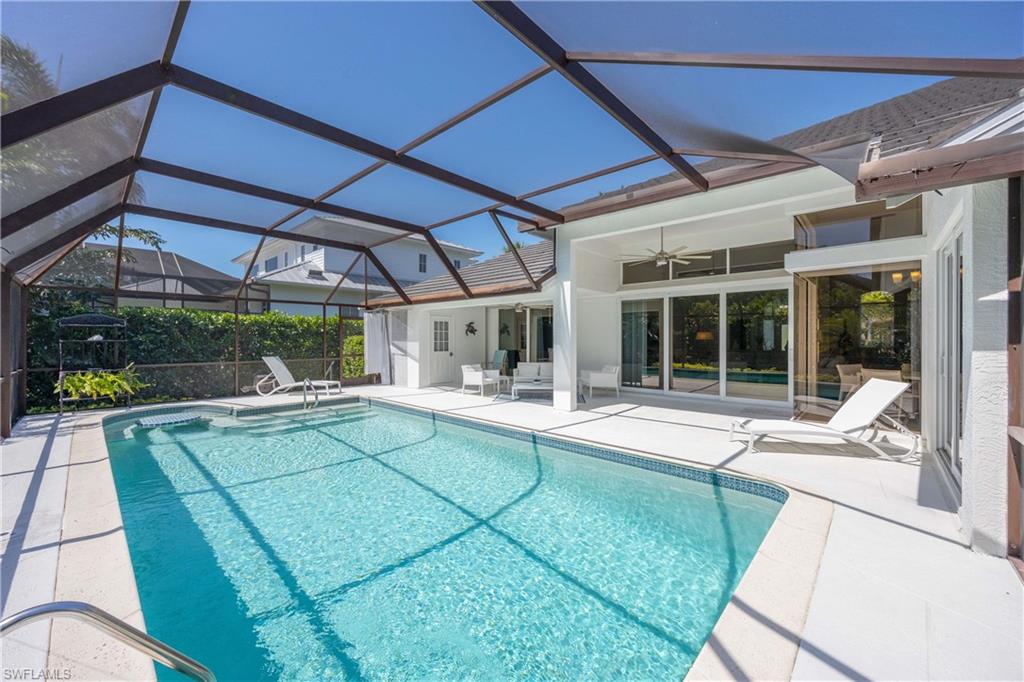 1850 Crayton Road Naples, FL 34102 - Photo 38 of 48 a view of a house with a backyard porch and sitting area
