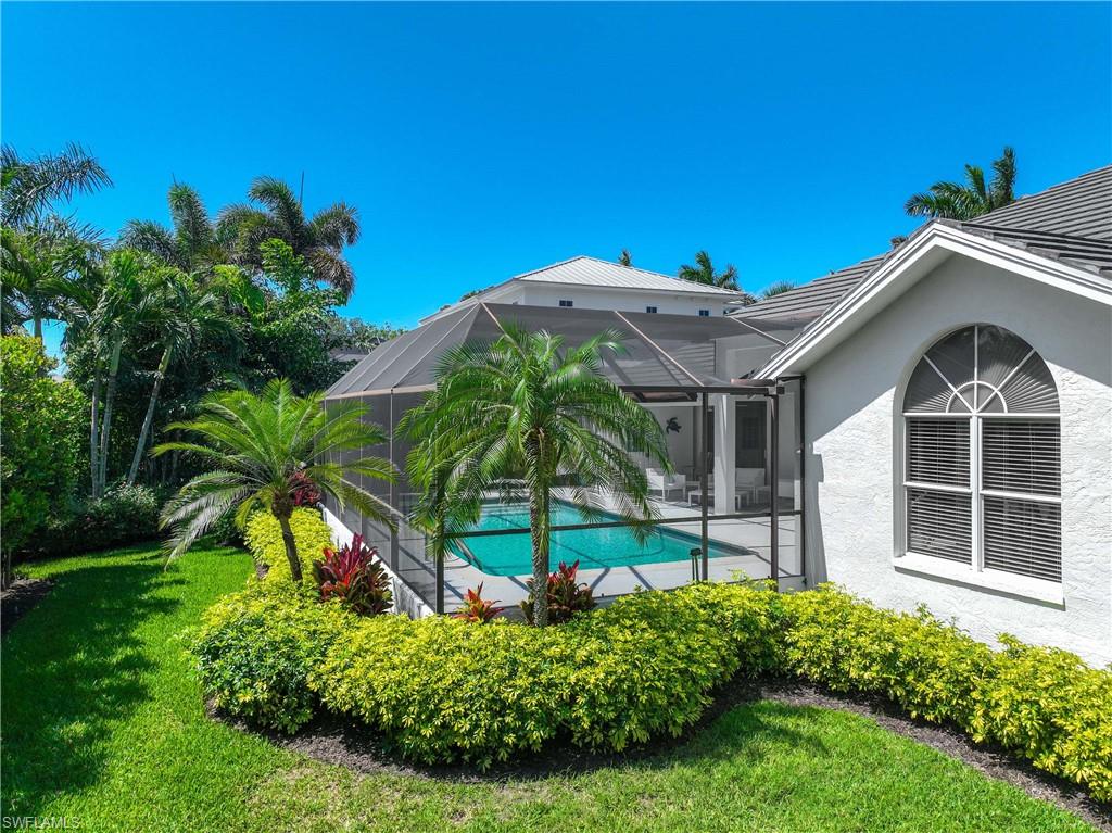 1850 Crayton Road Naples, FL 34102 - Photo 42 of 48 a front view of a house with a yard
