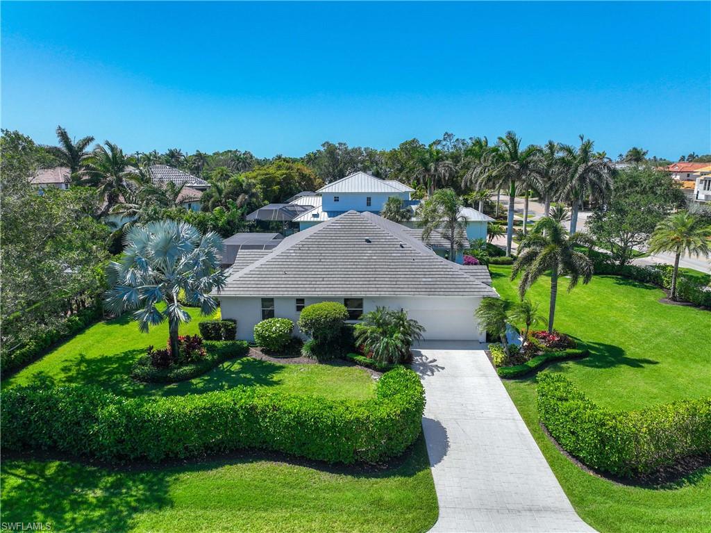 1850 Crayton Road Naples, FL 34102 - Photo 43 of 48 a front view of a house with a yard