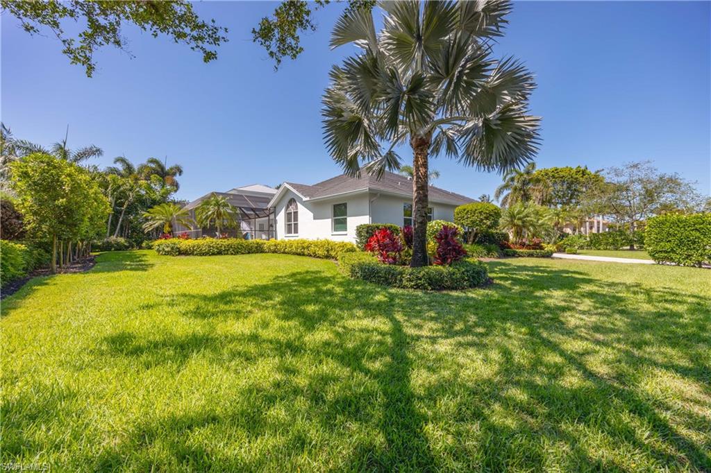 1850 Crayton Road Naples, FL 34102 - Photo 44 of 48 a front view of a house with garden