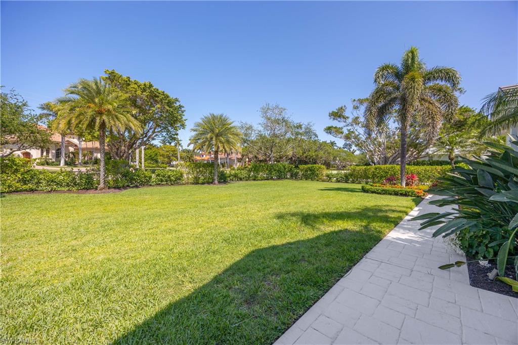1850 Crayton Road Naples, FL 34102 - Photo 7 of 48 a view of a garden with a building in the background