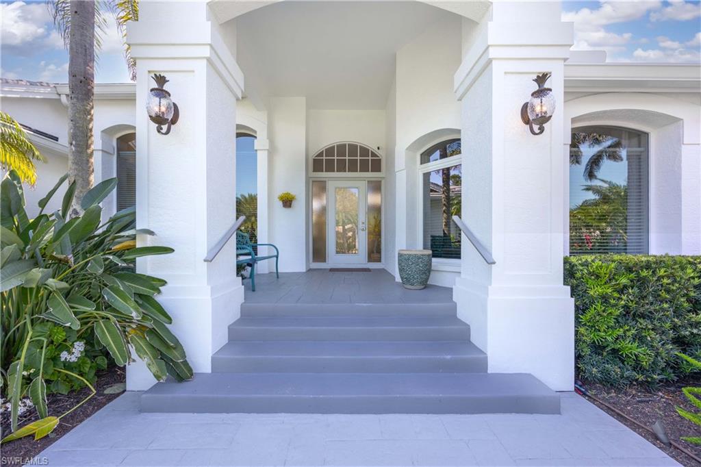 1850 Crayton Road Naples, FL 34102 - Photo 8 of 48 a front view of a house with a porch