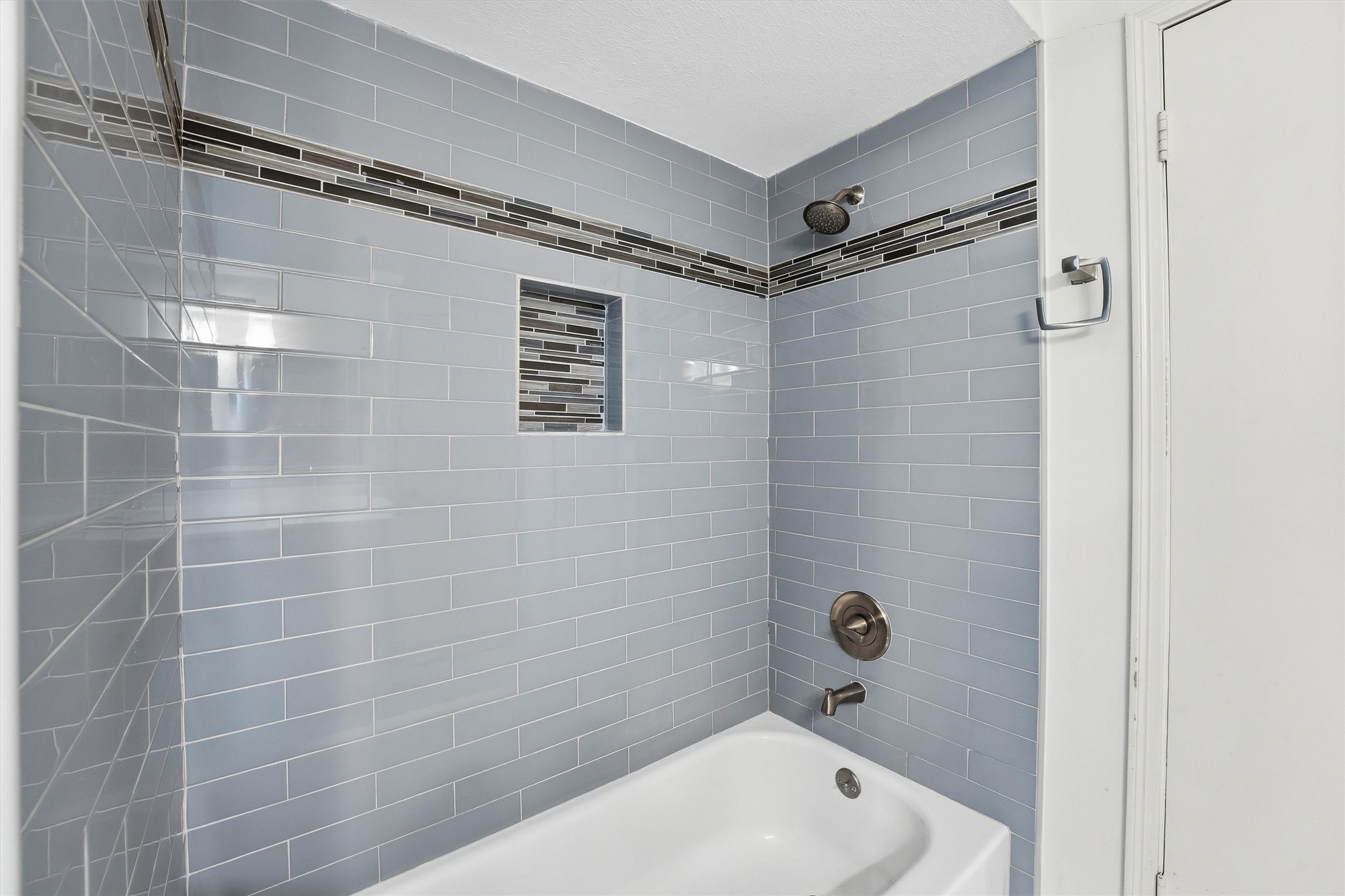 8115 Theisswood Road Spring, TX 77379 - Photo 26 of 36 a bathroom with a shower and a bathtub