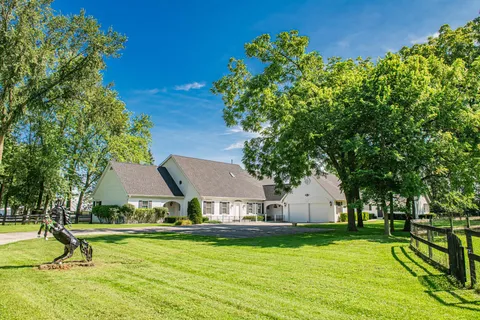 a view of a house with swimming pool and sitting area