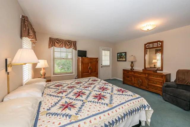 a bedroom with a large bed and a dresser