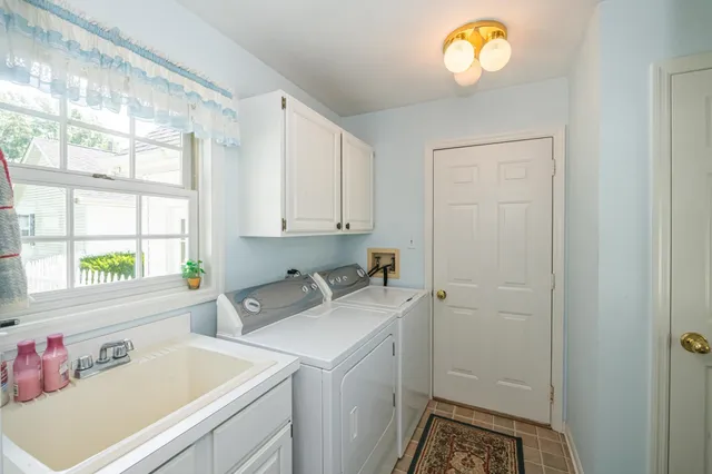 a view of storage and utility room with a window washer and dryer
