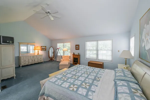 a bedroom with a large bed and a chandelier