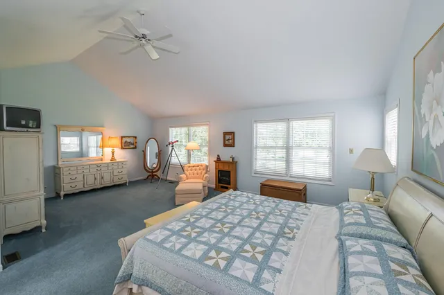 a bedroom with a large bed and a chandelier