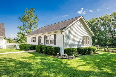 a view of a house with a backyard and a patio