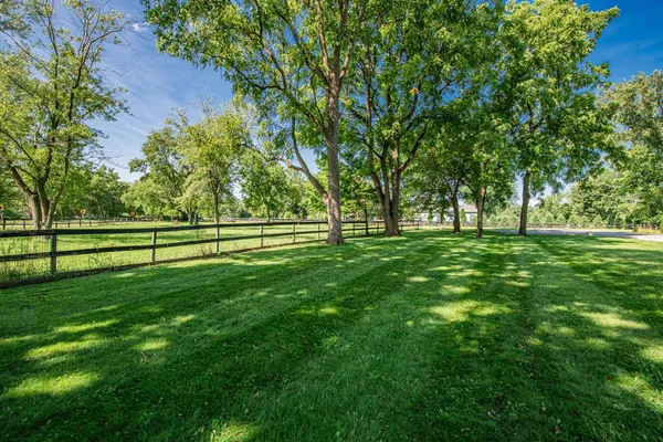 a view of grassy field with benches
