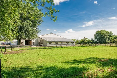 a swimming pool with outdoor seating and yard