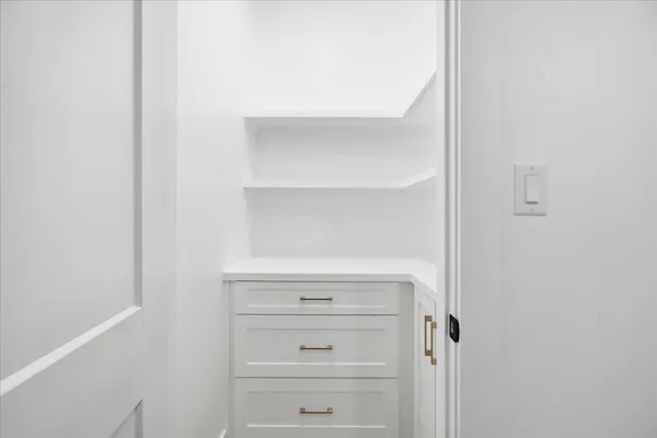a bedroom with a bed and a tv on the dresser