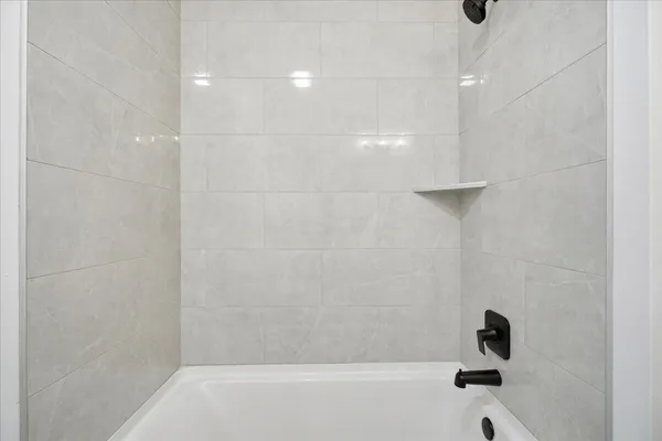 a bathroom with a toilet and a bathtub