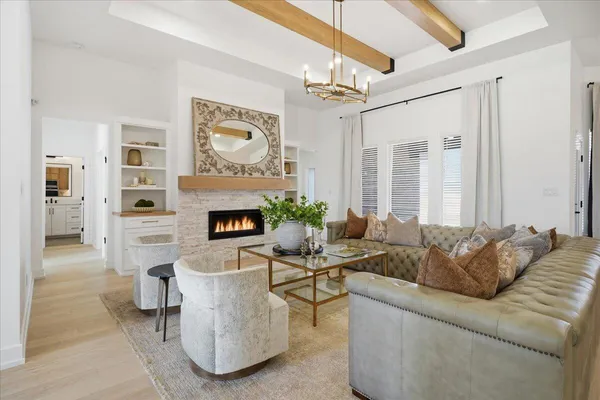 a living room with furniture and a chandelier