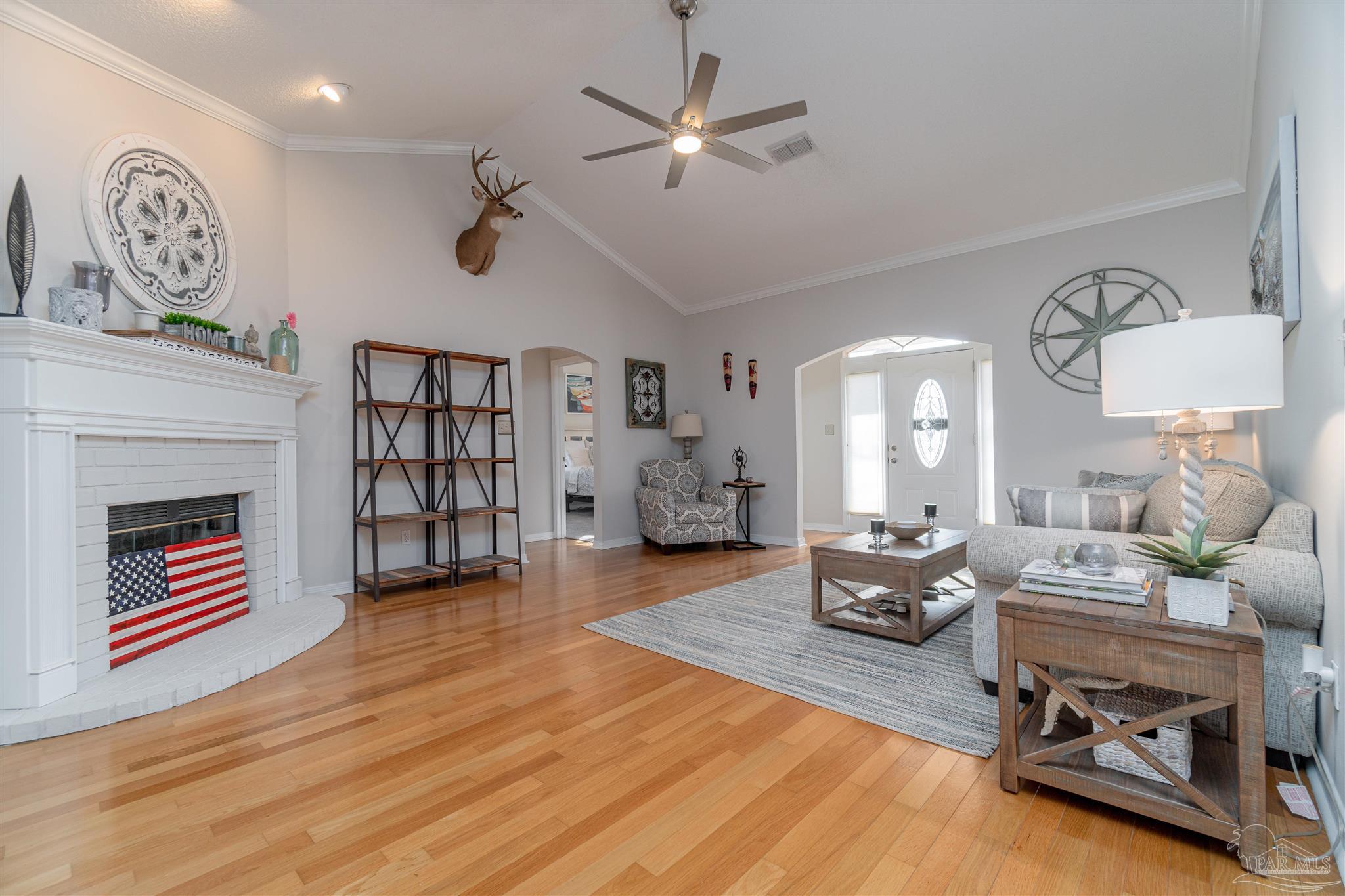 1504 Muirfield Road Cantonment, FL 32533 - Photo 12 of 17 a living room with furniture and a fireplace