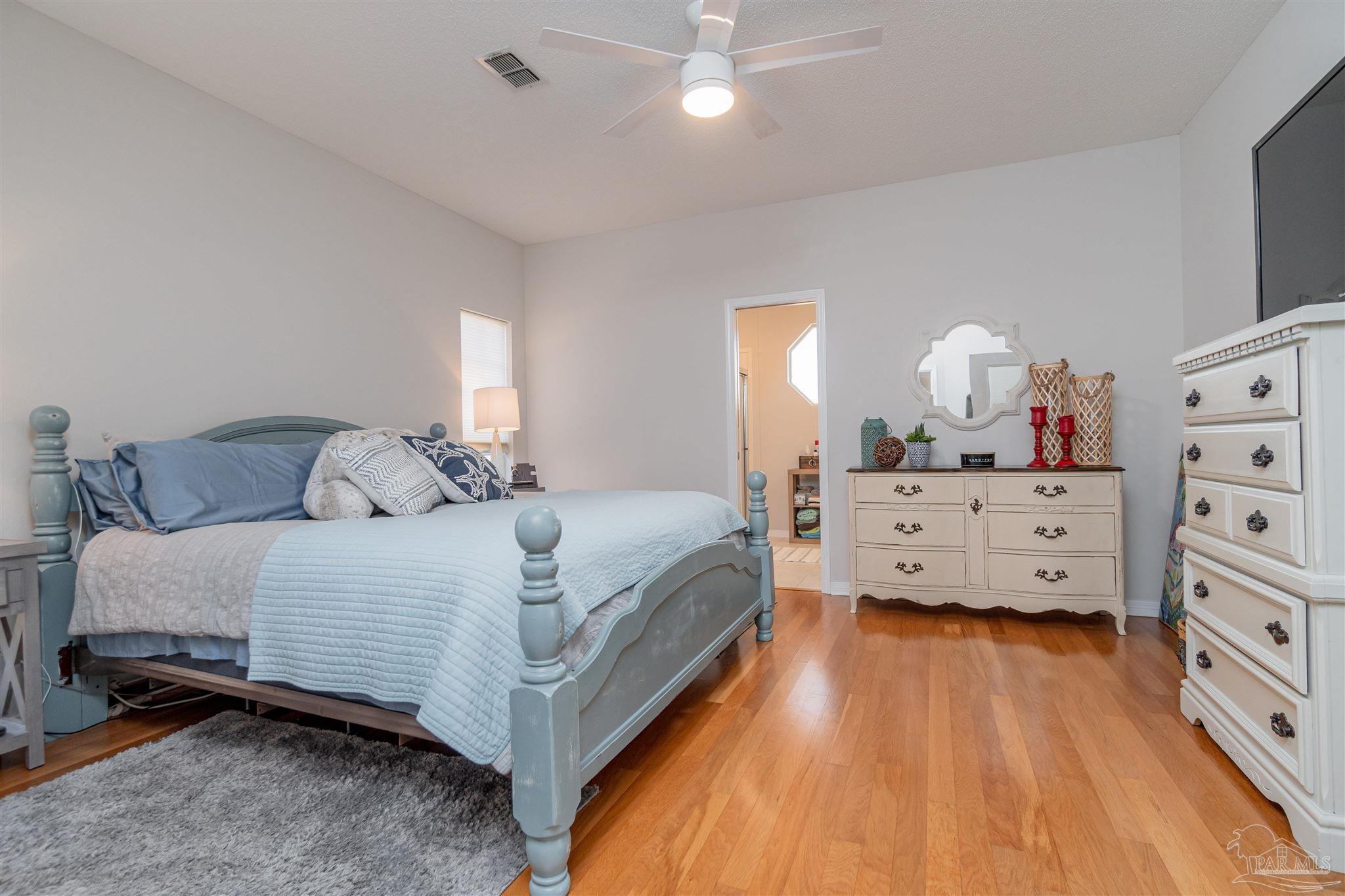 1504 Muirfield Road Cantonment, FL 32533 - Photo 13 of 17 a bedroom with a bed and a dresser