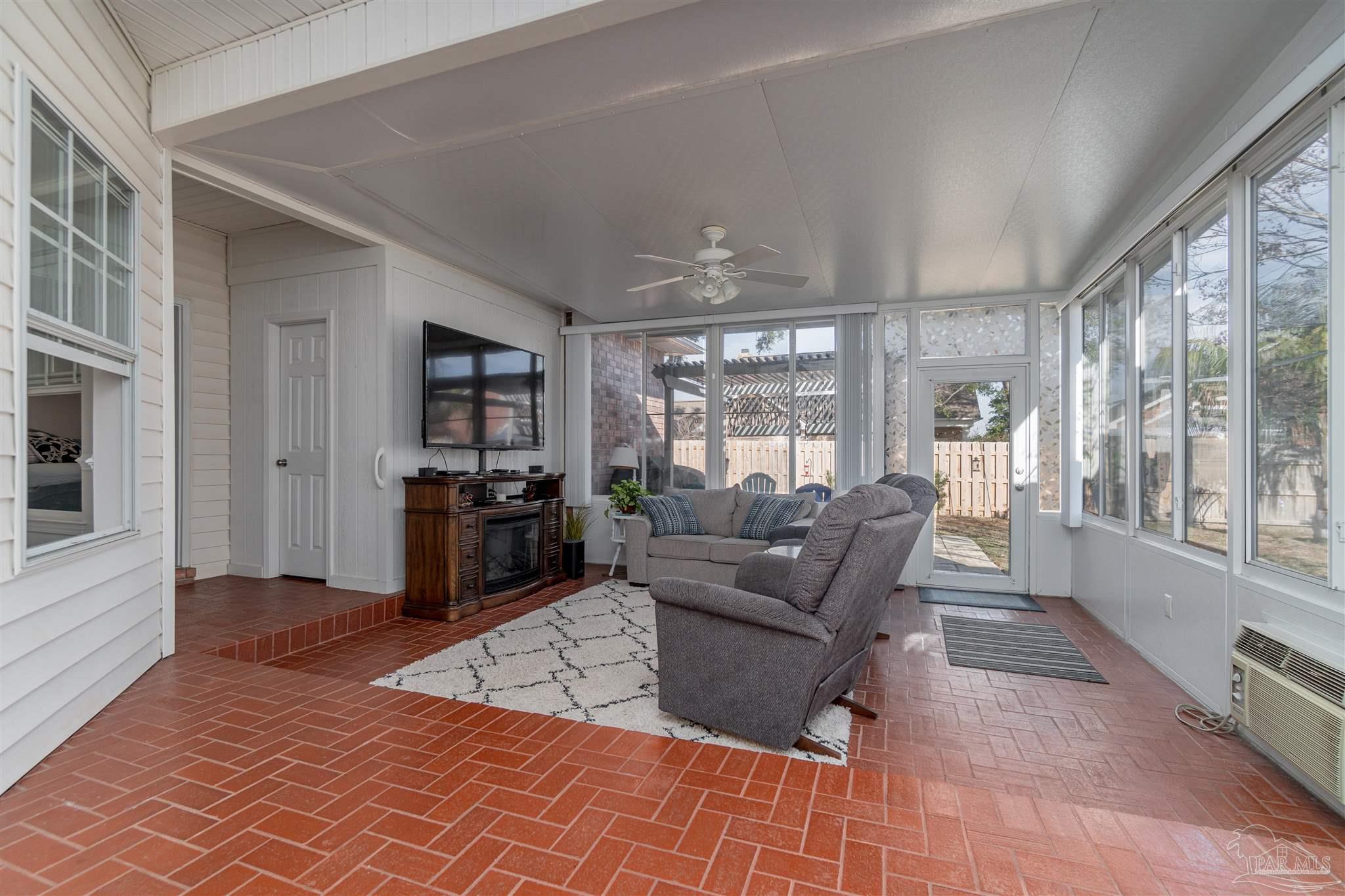 1504 Muirfield Road Cantonment, FL 32533 - Photo 15 of 17 a living room with furniture and a flat screen tv