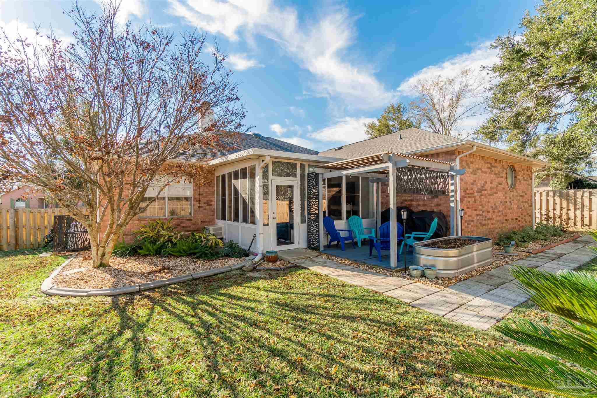 1504 Muirfield Road Cantonment, FL 32533 - Photo 17 of 17 a view of a house with large pool and sitting area