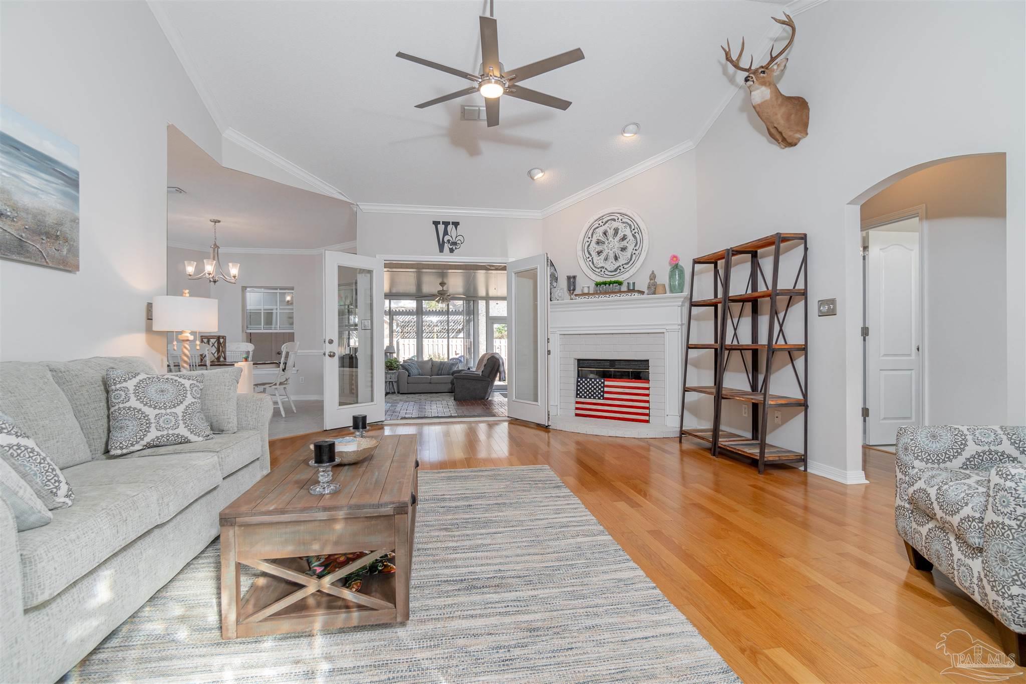 1504 Muirfield Road Cantonment, FL 32533 - Photo 2 of 17 a living room with furniture and a fireplace
