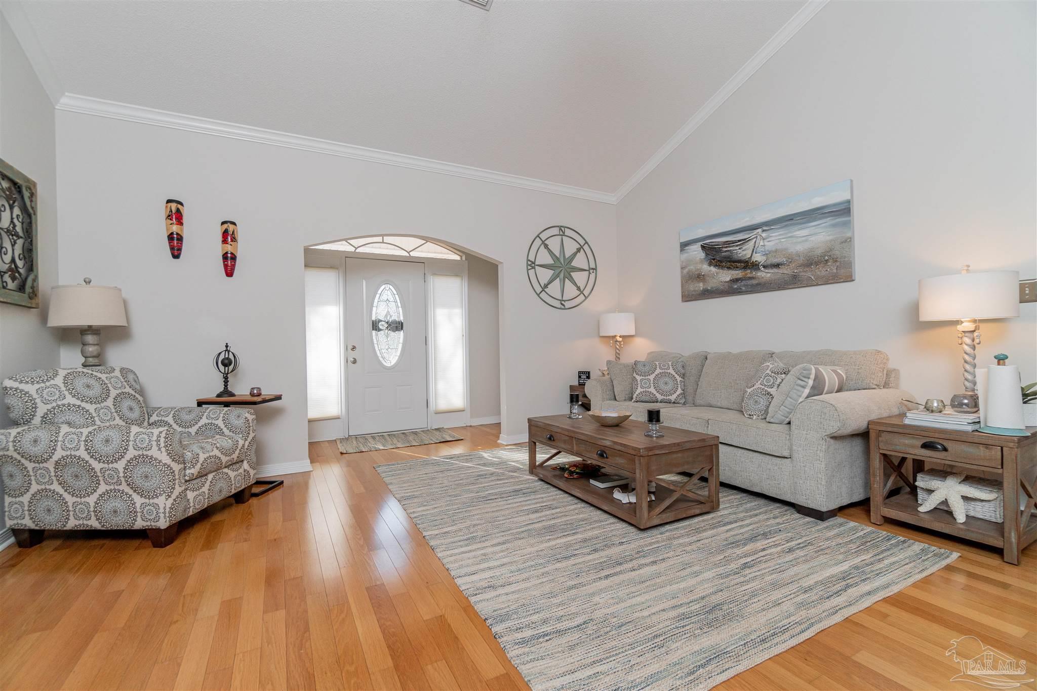 1504 Muirfield Road Cantonment, FL 32533 - Photo 3 of 17 a living room with furniture and a wooden floor