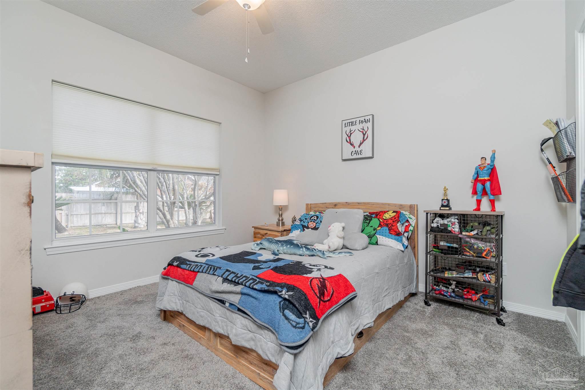 1504 Muirfield Road Cantonment, FL 32533 - Photo 6 of 17 a bedroom with furniture and a bed