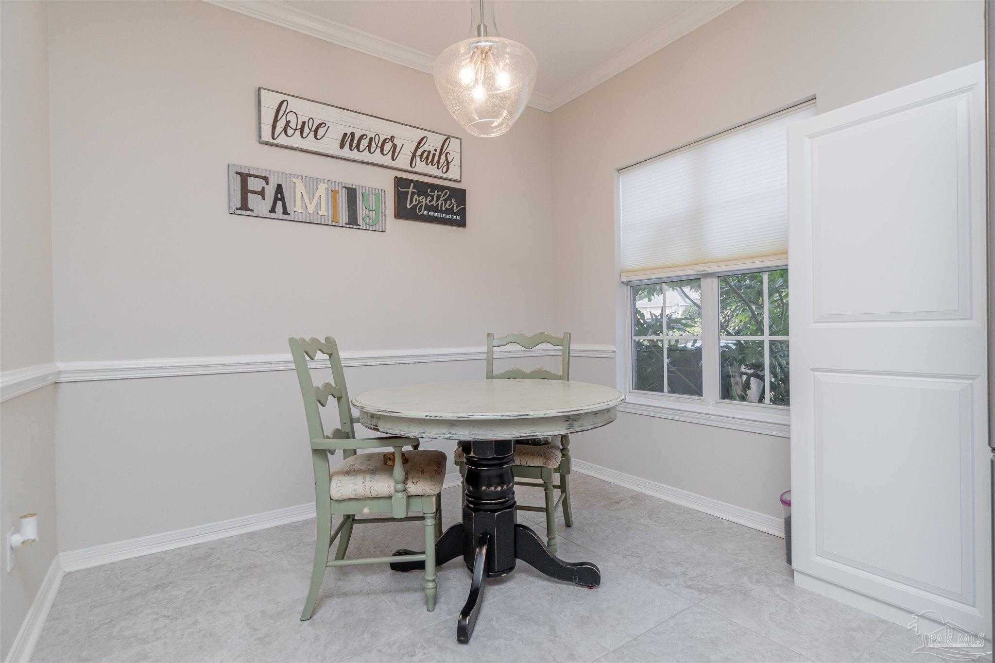 1504 Muirfield Road Cantonment, FL 32533 - Photo 9 of 17 a view of a dining room with furniture window and outside view