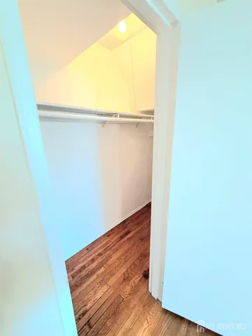 a view of a room with wooden floor and brick wall