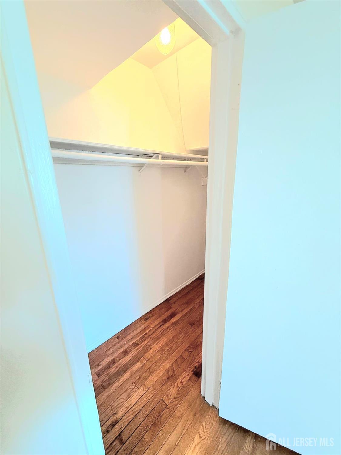 182 Evergreen Road, Unit 15A Edison, NJ 08837 - Photo 3 of 5 a view of a room with wooden floor and brick wall