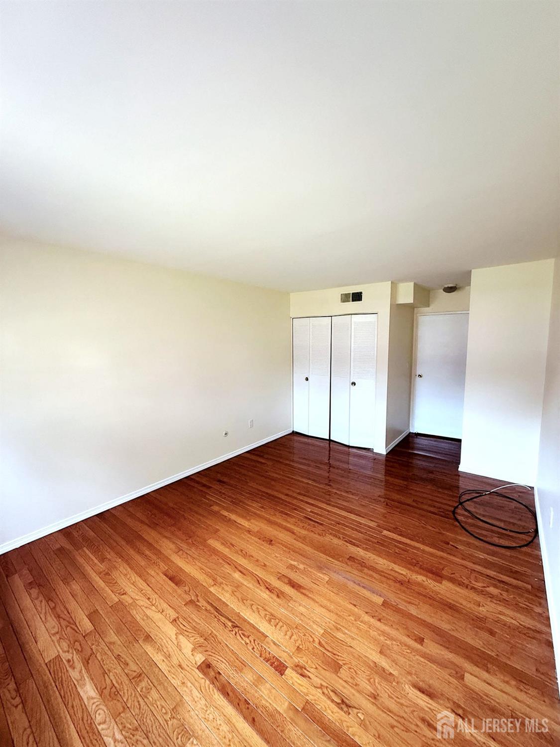 182 Evergreen Road, Unit 15A Edison, NJ 08837 - Photo 5 of 5 a view of a room with wooden floor