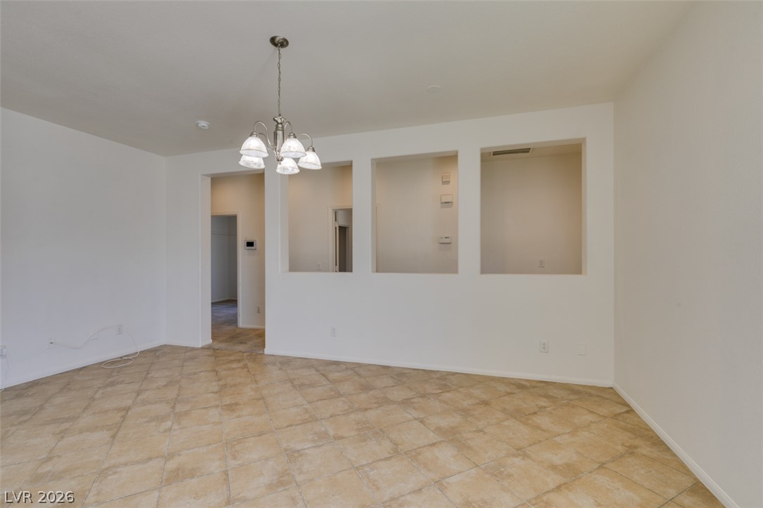 5150 Riverside Run Court North Las Vegas, NV 89081 - Photo 21 of 50 A graceful chandelier illuminates the generously proportioned space, featuring inviting tile flooring.
