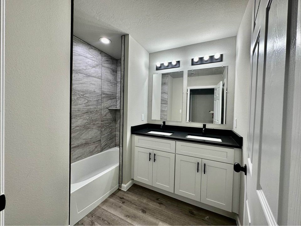 4302 Hirsch Road, Unit B Houston, TX 77026 - Photo 18 of 24 a bathroom with a granite countertop sink and a mirror