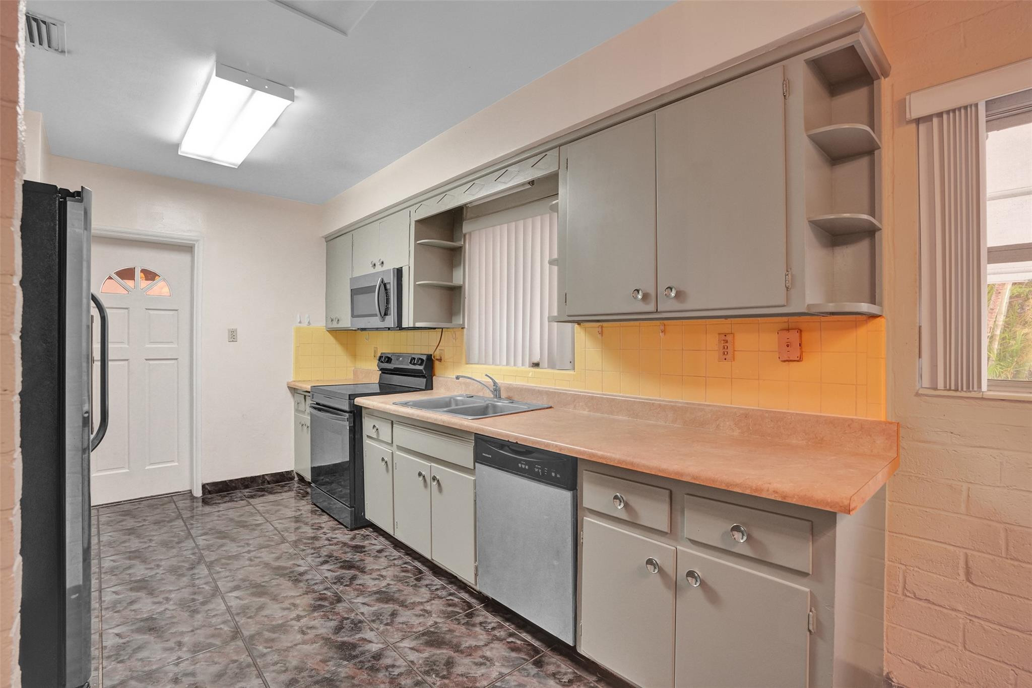 225 Pocatella Street Miami Springs, FL 33166 - Photo 11 of 56 a kitchen with a sink stove and cabinets