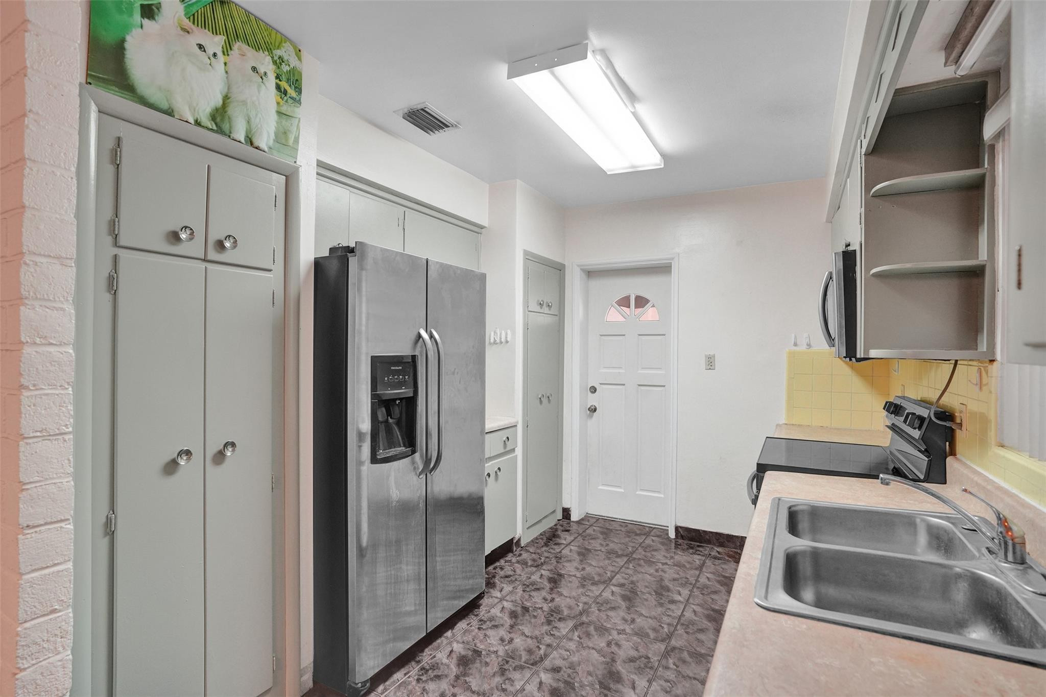 225 Pocatella Street Miami Springs, FL 33166 - Photo 12 of 56 a kitchen with stainless steel appliances granite countertop a refrigerator and a sink