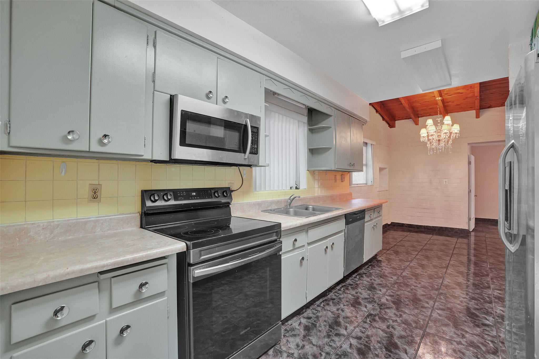 225 Pocatella Street Miami Springs, FL 33166 - Photo 13 of 56 a kitchen with a sink and a stove top oven