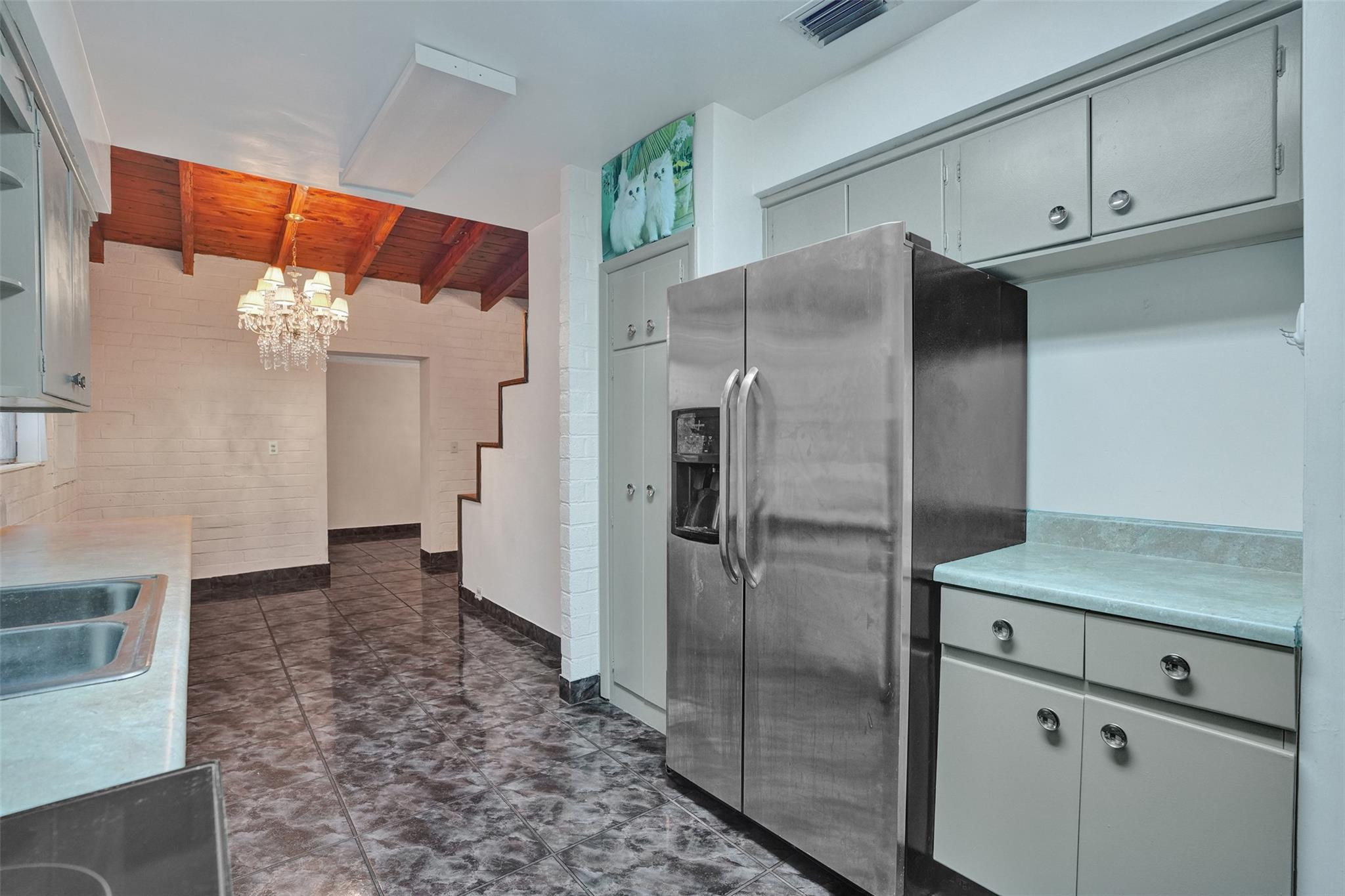 225 Pocatella Street Miami Springs, FL 33166 - Photo 14 of 56 a kitchen with stainless steel appliances granite countertop a refrigerator and a sink