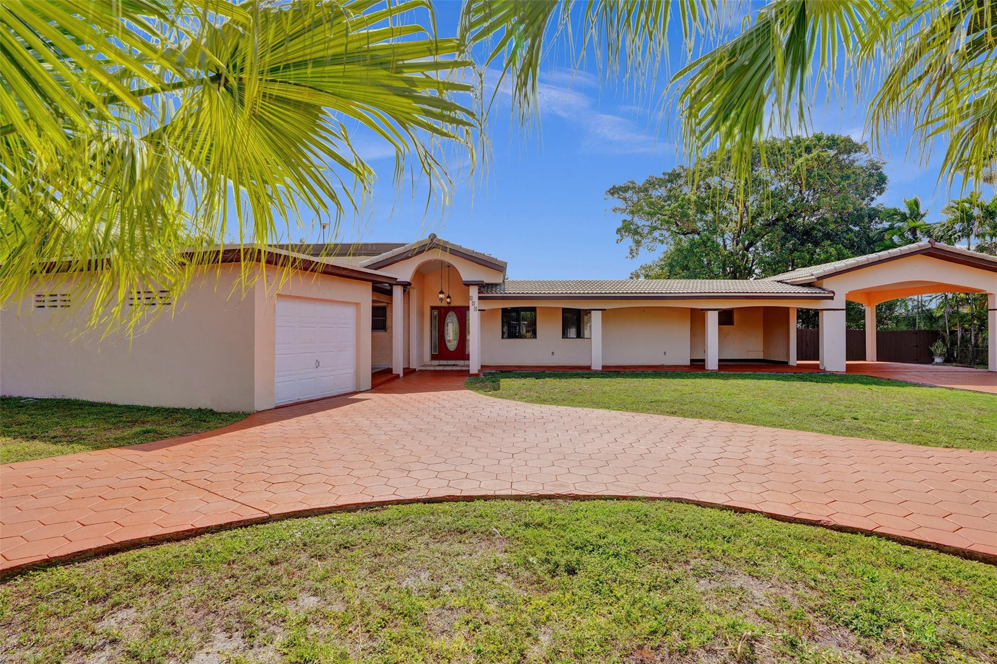 225 Pocatella Street Miami Springs, FL 33166 - Photo 2 of 56 a front view of house with yard and green space