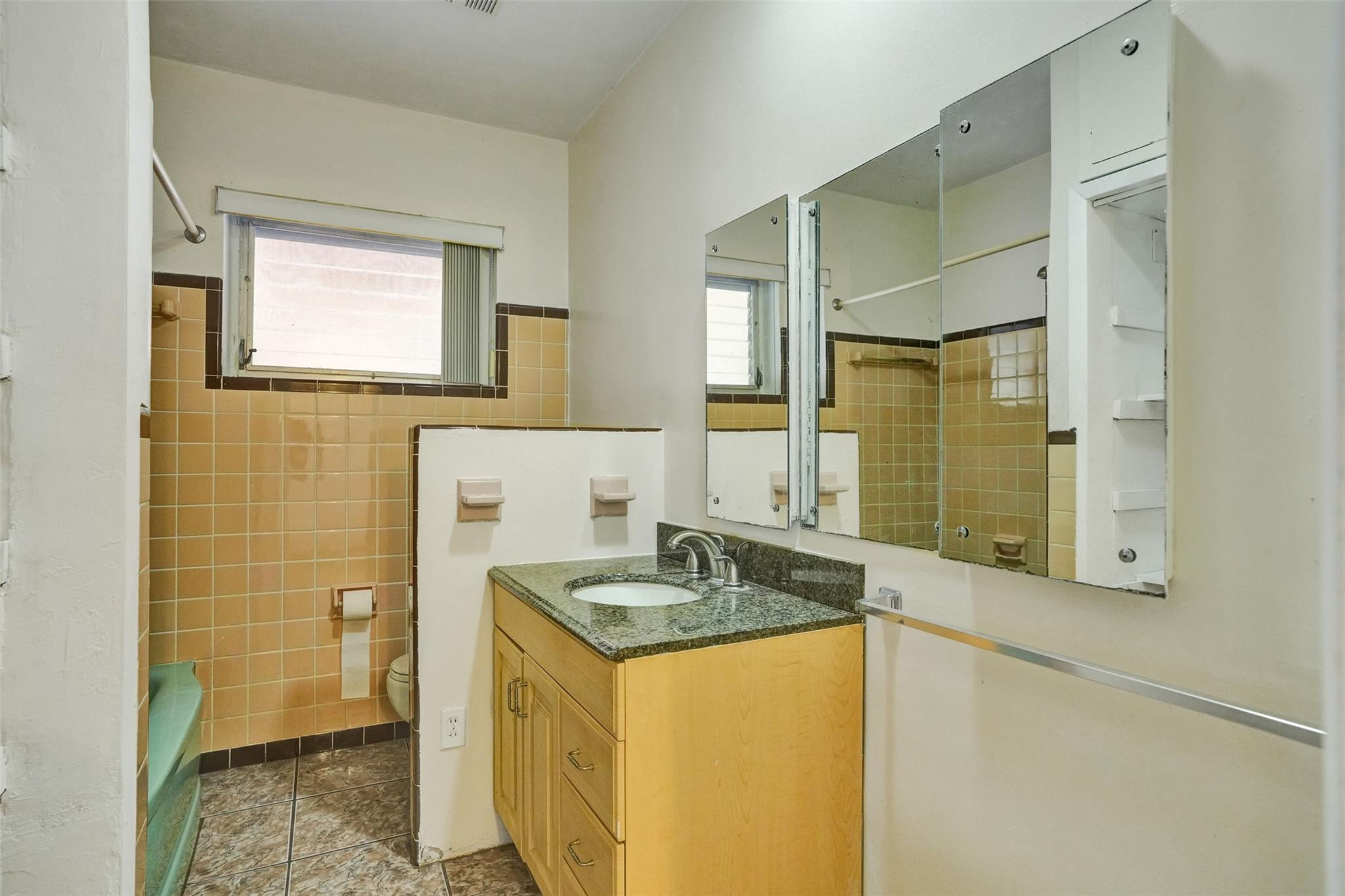 225 Pocatella Street Miami Springs, FL 33166 - Photo 30 of 56 a bathroom with a granite countertop sink and a mirror