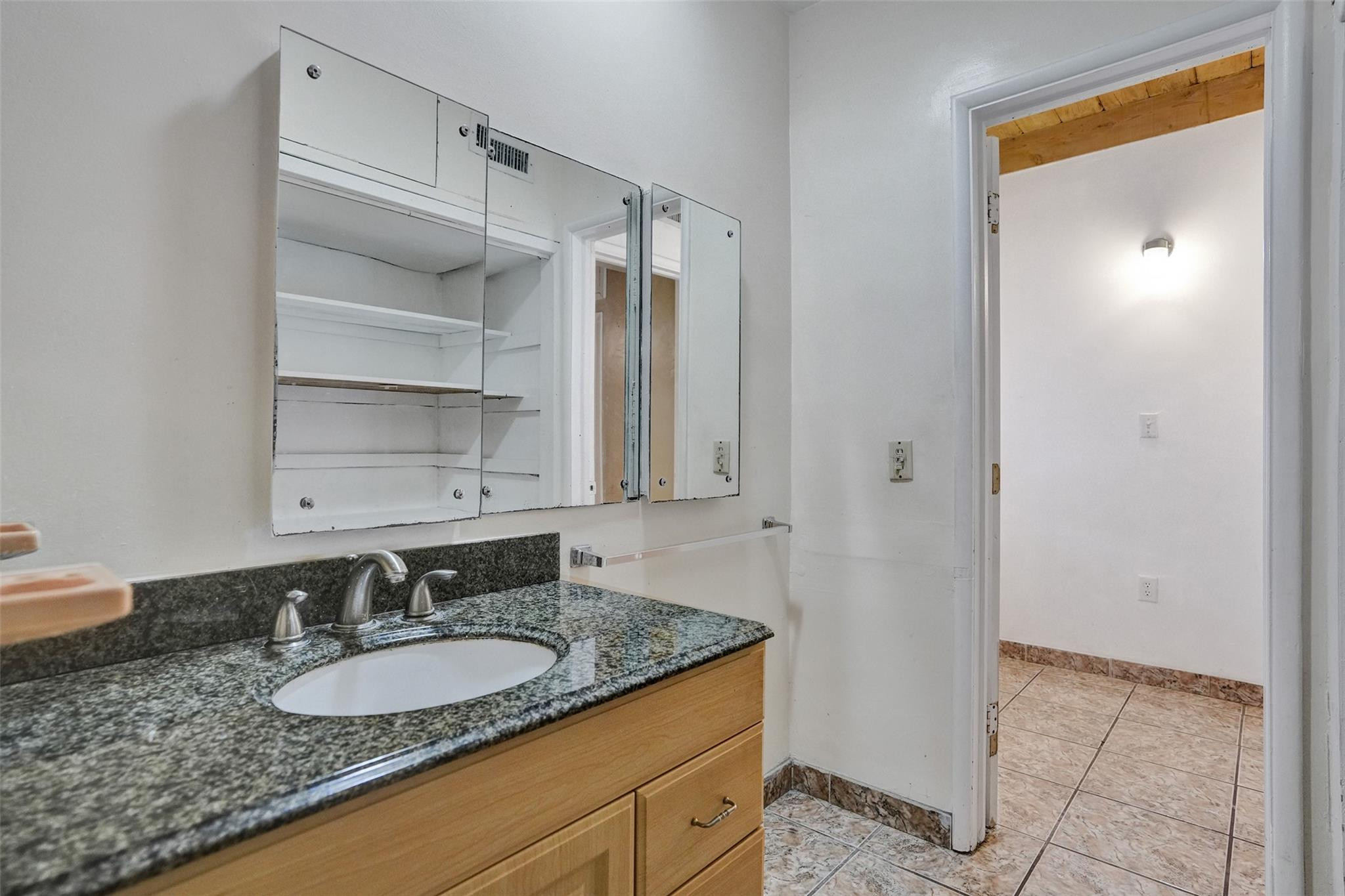 225 Pocatella Street Miami Springs, FL 33166 - Photo 32 of 56 a bathroom with a granite countertop sink and a mirror