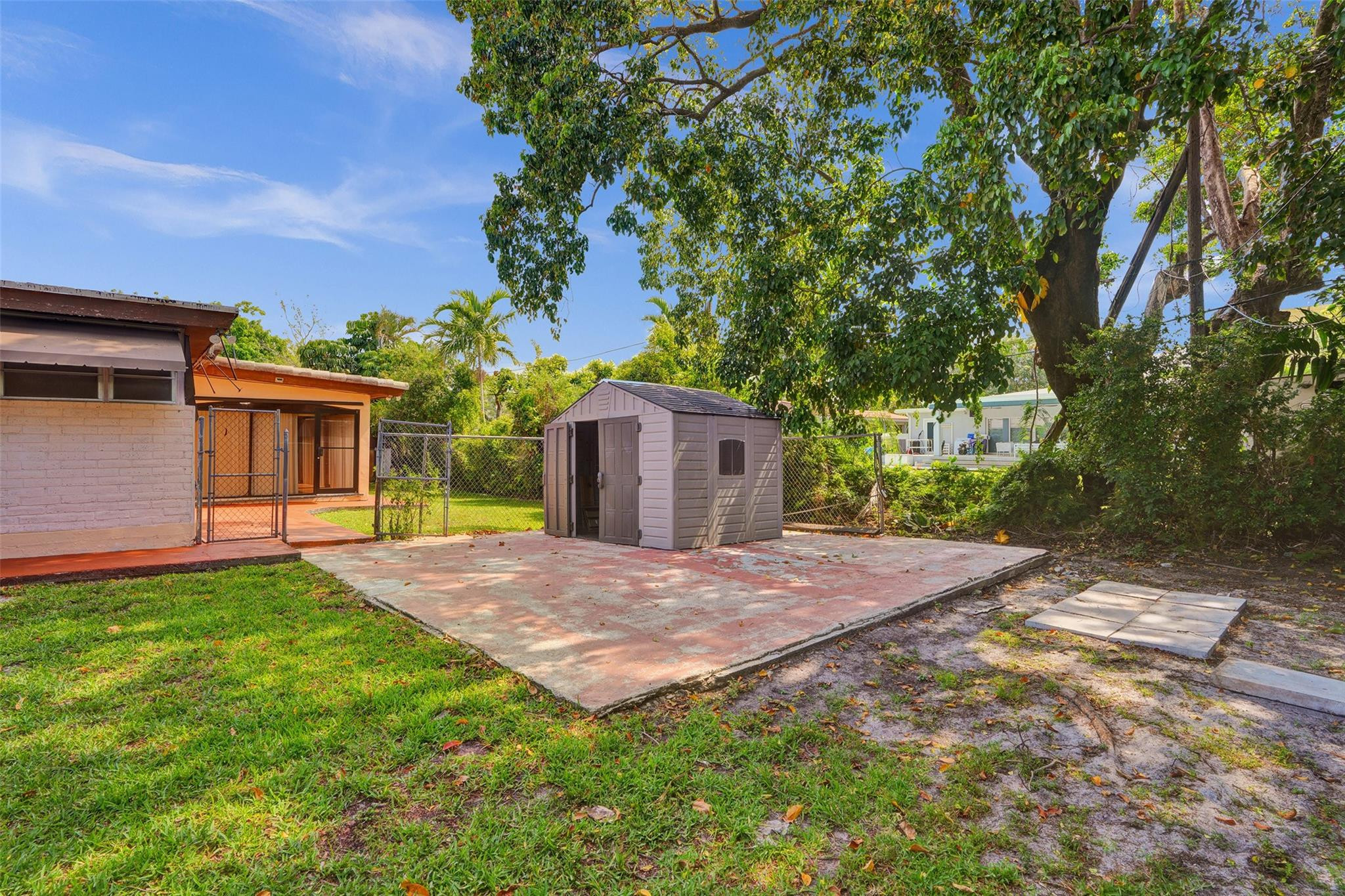 225 Pocatella Street Miami Springs, FL 33166 - Photo 44 of 56 a view of a yard with a house and a large tree