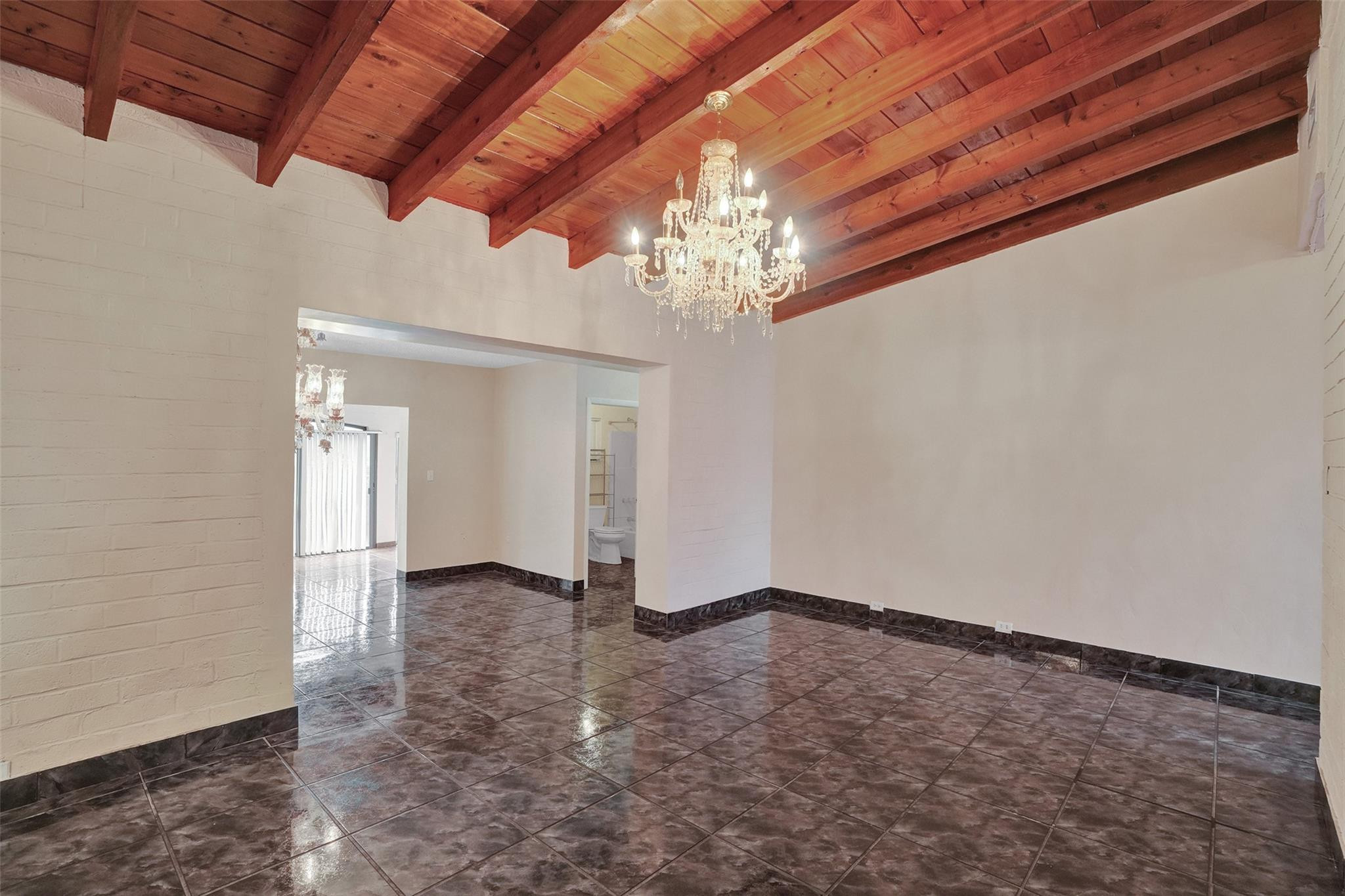 225 Pocatella Street Miami Springs, FL 33166 - Photo 7 of 56 a view of an empty room with a chandelier