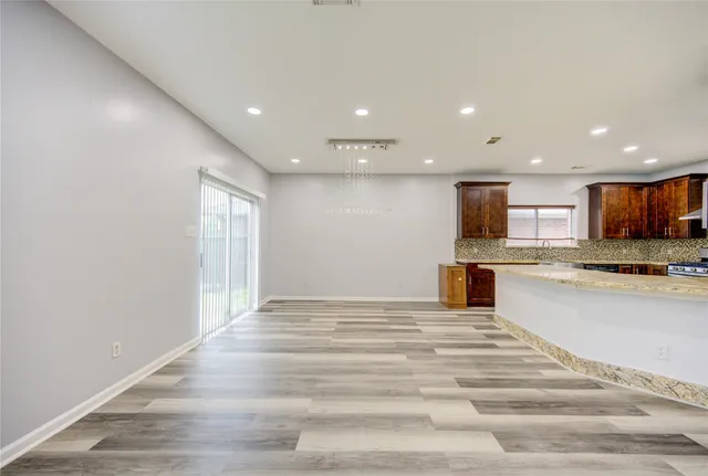 a view of kitchen with kitchen island microwave and refrigerator