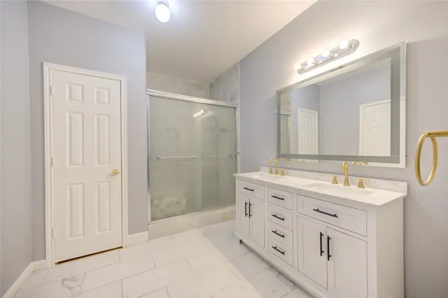 a spacious bathroom with a shower and a sink