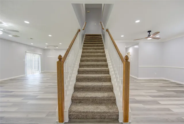 a view of entryway and hall with wooden floor