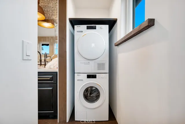 a kitchen with a sink and a wooden floor