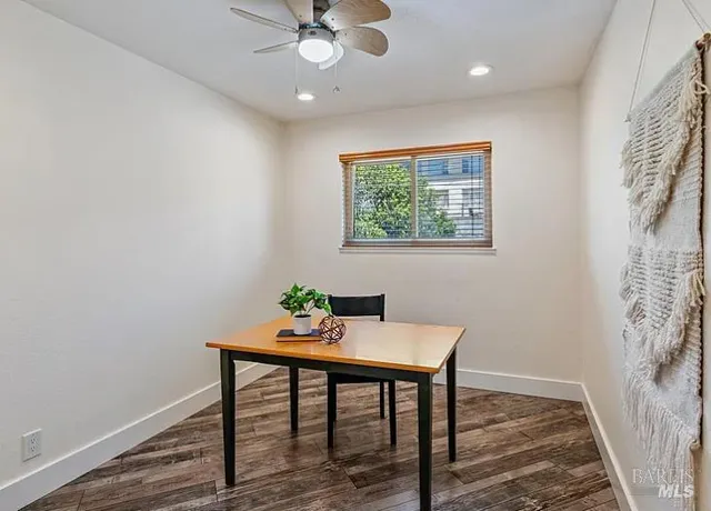 a workspace room with furniture and wooden floor
