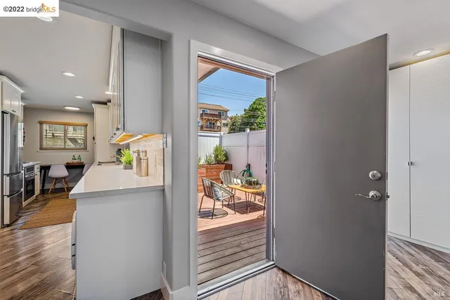 a kitchen with stainless steel appliances a stove a microwave cabinets and a dining table