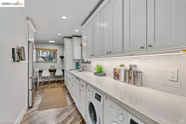 a kitchen with stainless steel appliances granite countertop a lot of counter space and wooden floors