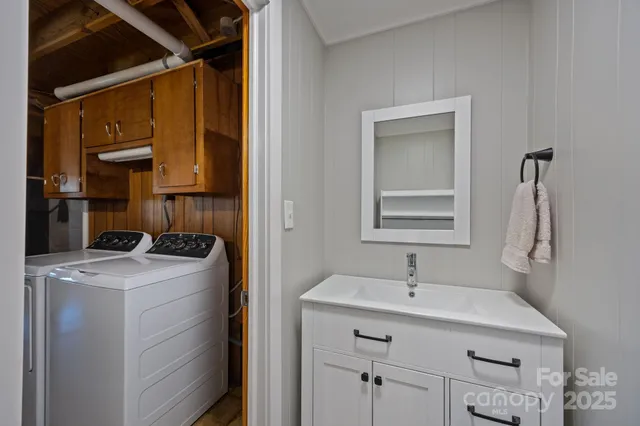 a utility room with cabinets washer and dryer