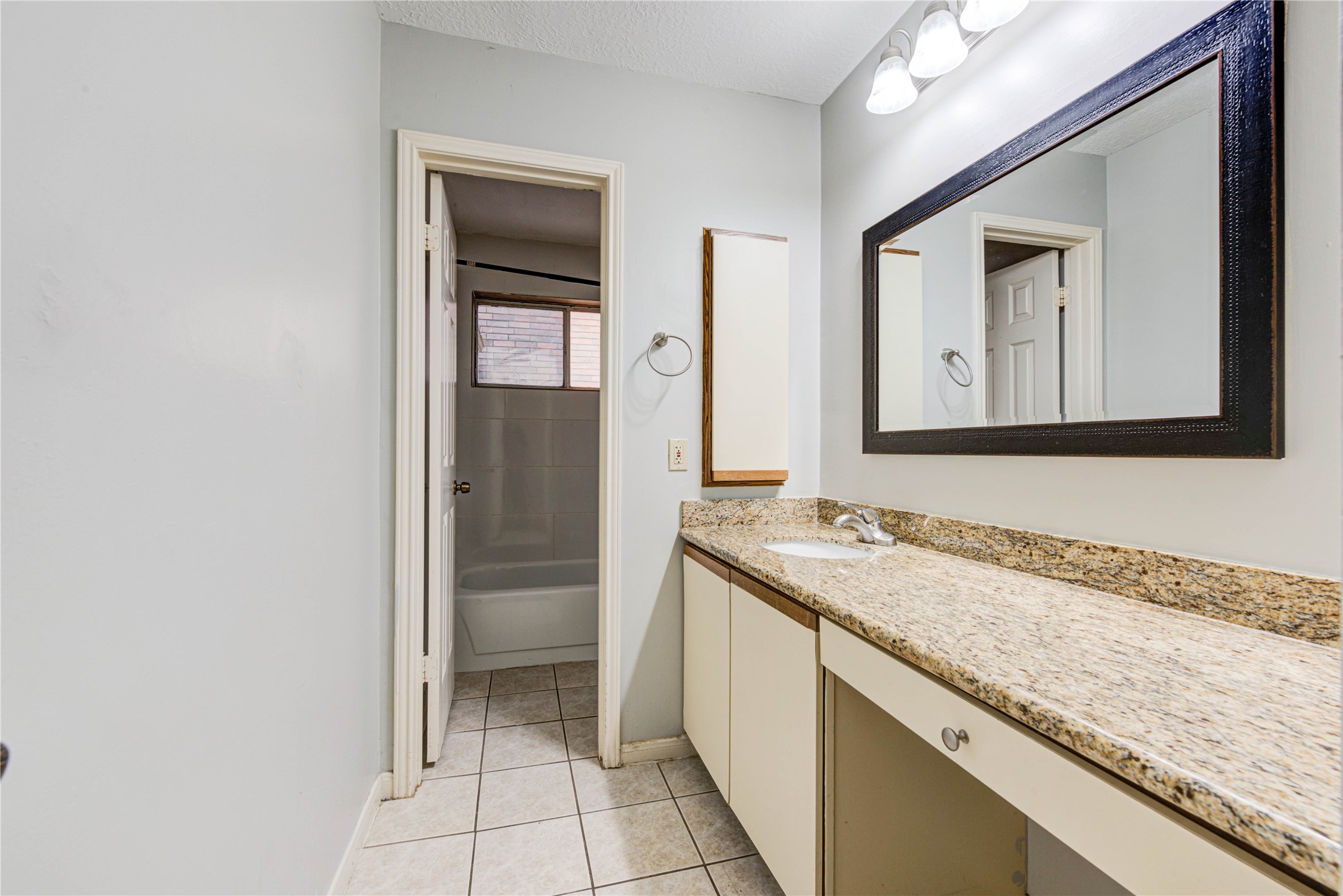 2122 Paso Rello Drive Houston, TX 77077 - Photo 12 of 20 a bathroom with a granite countertop sink and a mirror