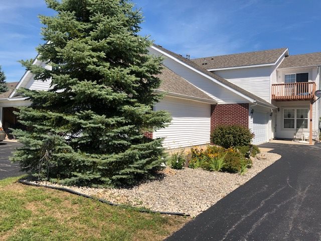 10149 Monarch Road, Unit 4 Roscoe, IL 61073 - Photo 1 of 21 a front view of a house with a yard